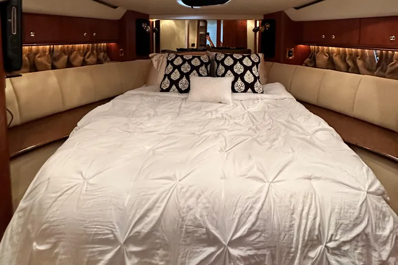  Yacht Photos Pics Luxurious bedroom interior of 1999 Cruisers 5000 Sedan Sport yacht with plush bedding.
