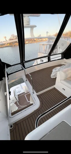  Yacht Photos Pics 1999 Cruisers 5000 Sedan Sport yacht interior with wooden deck and seating area.