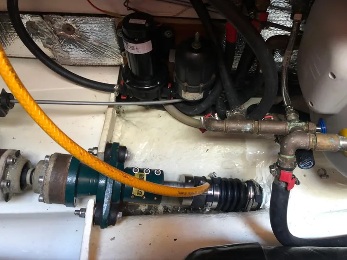 Maloose Yacht Photos Pics Engine compartment of a 2001 Malo 43 sailboat, showing mechanical components and hoses.