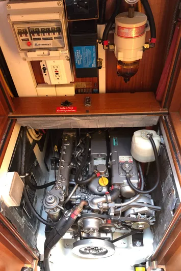Maloose Yacht Photos Pics Engine compartment of a 2001 Malo 43 sailboat, showcasing mechanical components and electrical systems.