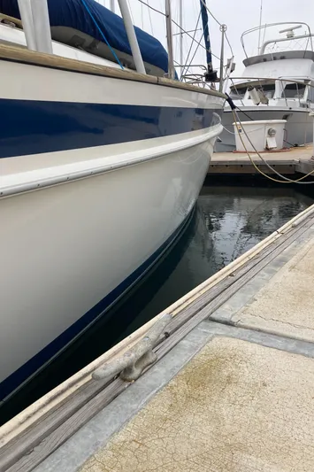 Maloose Yacht Photos Pics Sailboat Malo 43, 2001 model, docked at marina with other boats.