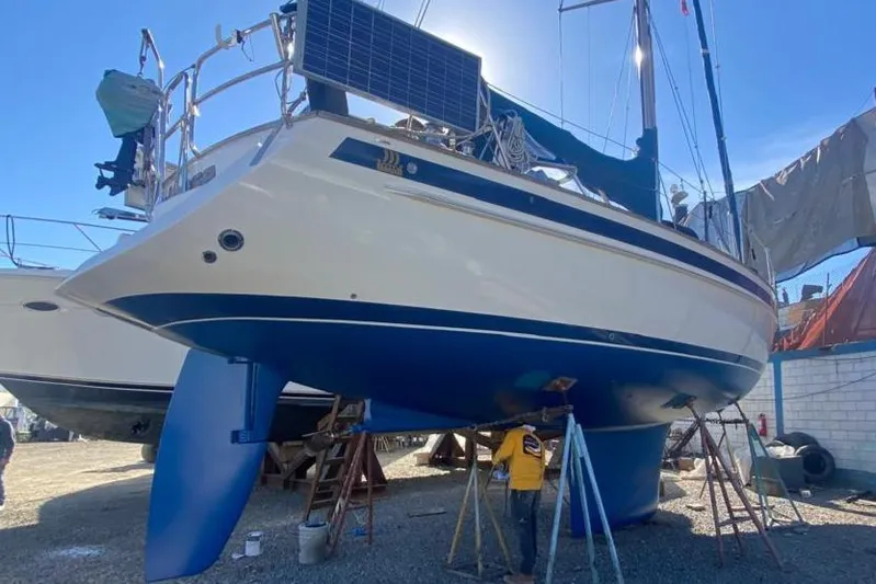 Maloose Yacht Photos Pics Sailboat Malo 43, 2001 model, in dry dock with solar panels and blue hull.