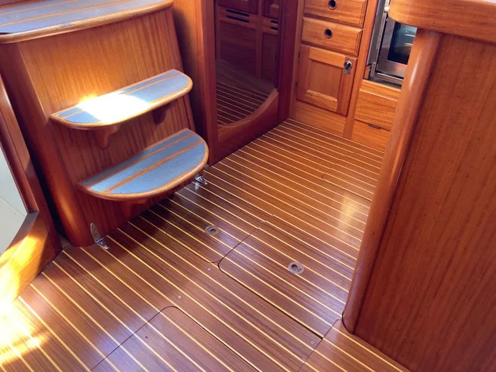 Maloose Yacht Photos Pics Wooden interior of a 2001 Malo 43 yacht, featuring steps and cabinetry.