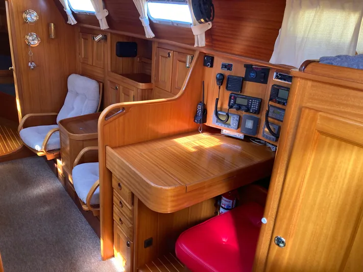 Maloose Yacht Photos Pics Interior of a 2001 Malo 43 yacht with wooden furnishings and navigation equipment.