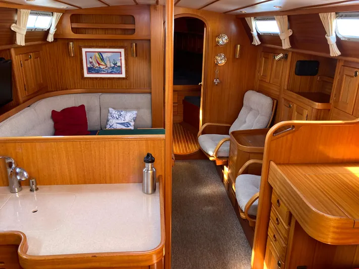 Maloose Yacht Photos Pics Interior of 2001 Malo 43 yacht with wooden furnishings and cozy seating area.