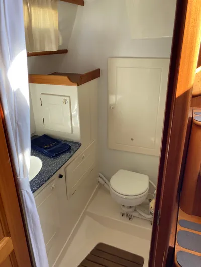 Maloose Yacht Photos Pics Compact bathroom in a 2001 Malo 43 yacht, featuring a toilet and sink.