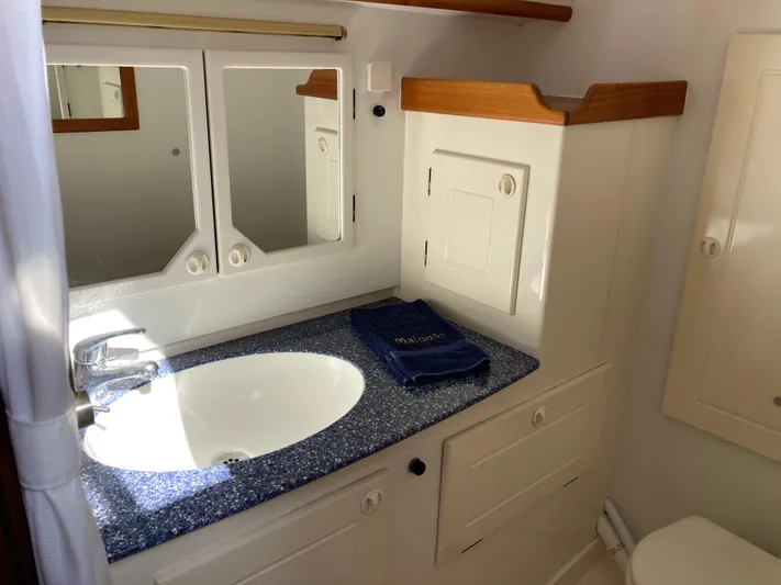 Maloose Yacht Photos Pics Bathroom interior of a 2001 Malo 43 yacht with sink and mirror.