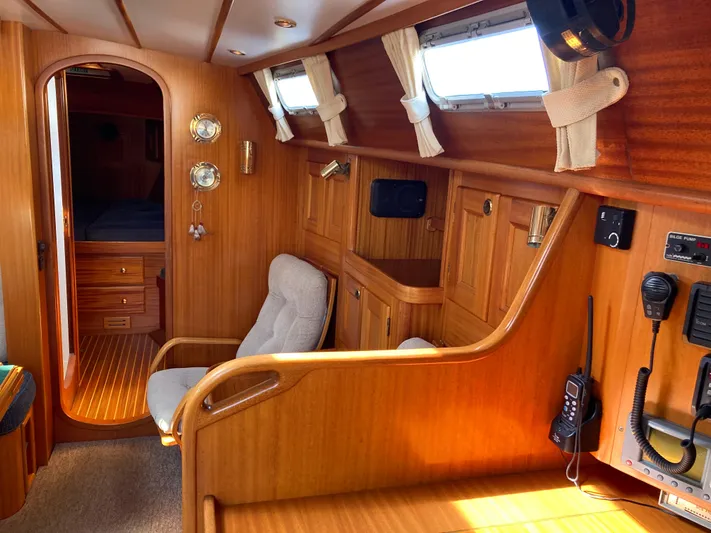 Maloose Yacht Photos Pics Interior of a 2001 Malo 43 yacht with wooden paneling and nautical instruments.