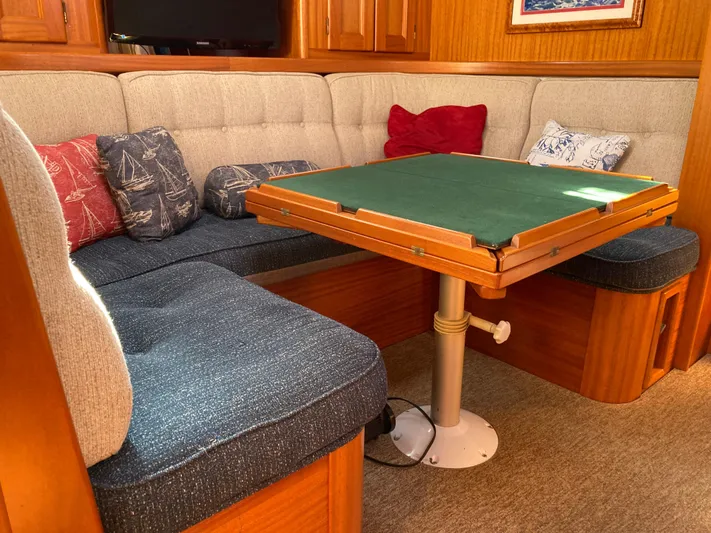 Maloose Yacht Photos Pics Cozy Malo 43 yacht interior with cushioned seating and a wooden table, 2001 model.