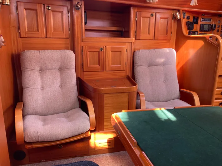 Maloose Yacht Photos Pics Interior of a 2001 Malo 43 yacht with wooden cabinetry and cushioned seating.