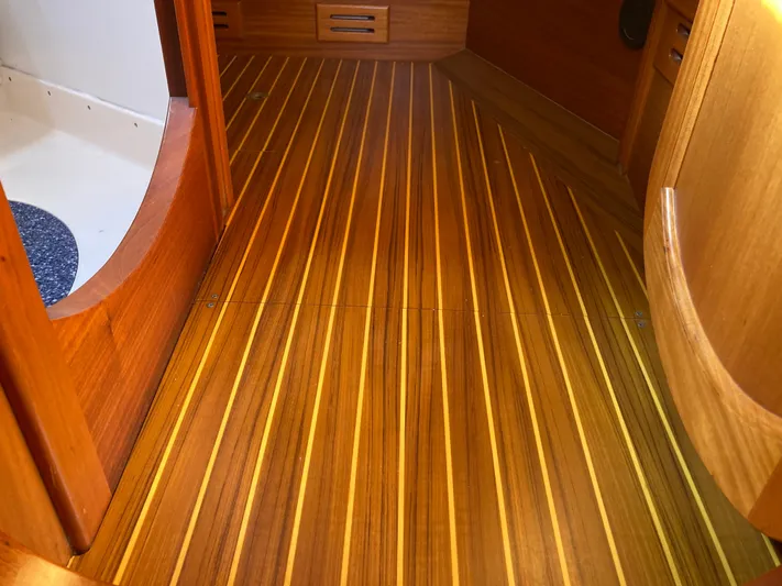 Maloose Yacht Photos Pics Wooden interior flooring of a 2001 Malo 43 boat, featuring sleek, polished finish.