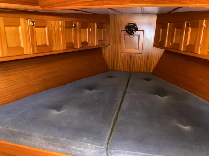 Maloose Yacht Photos Pics Cozy Malo 43 yacht cabin interior with wooden cabinets and blue cushions, 2001 model.