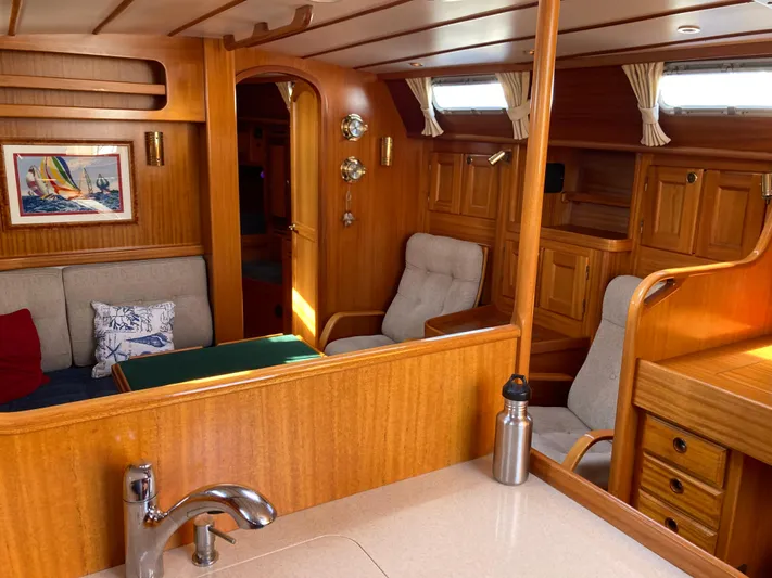 Maloose Yacht Photos Pics Interior of 2001 Malo 43 yacht with wooden finish and cozy seating area.