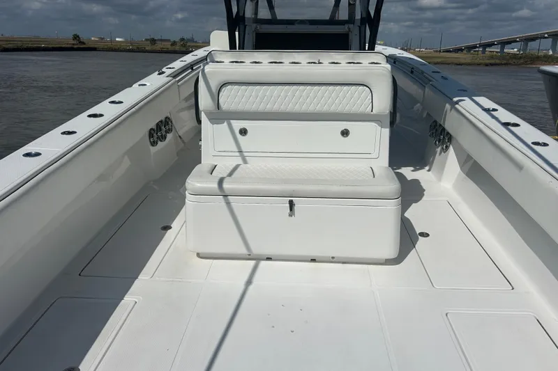  Yacht Photos Pics 2016 SeaHunter 39 Tournament boat interior with white seating and storage, on calm water.
