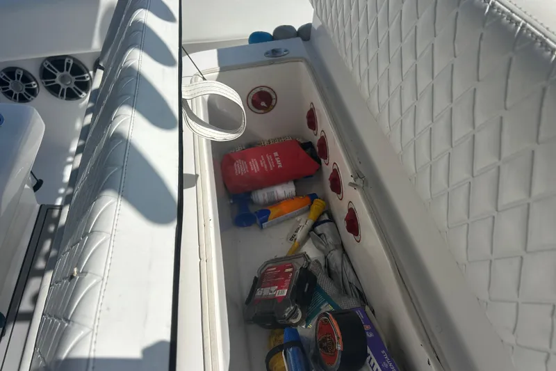  Yacht Photos Pics Storage compartment on a 2016 SeaHunter 39 Tournament boat with various items inside.