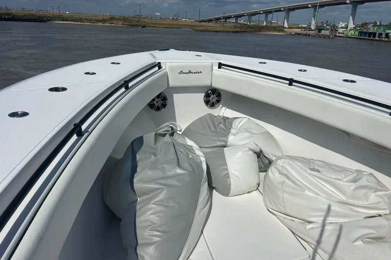  Yacht Photos Pics 2016 SeaHunter 39 Tournament boat with white deck and bean bags, near a bridge.