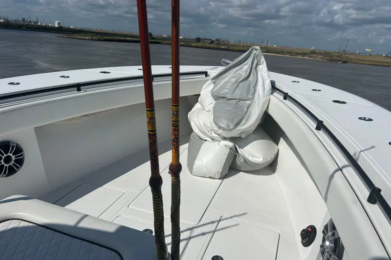  Yacht Photos Pics 2016 SeaHunter 39 Tournament boat deck with fishing rods and cushions, on a calm river.