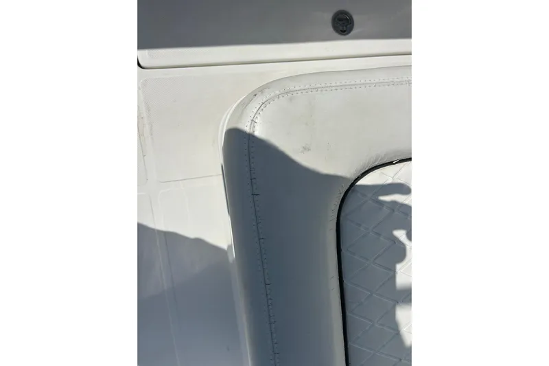  Yacht Photos Pics White interior detail of a 2016 SeaHunter 39 Tournament boat, featuring cushioned seating.