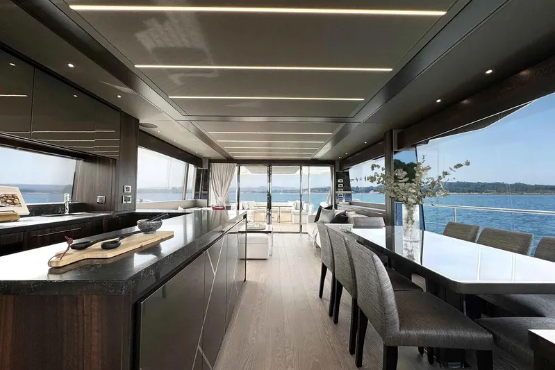  Yacht Photos Pics Luxurious interior of 2023 Sunseeker 76 Yacht with elegant dining area and ocean view.