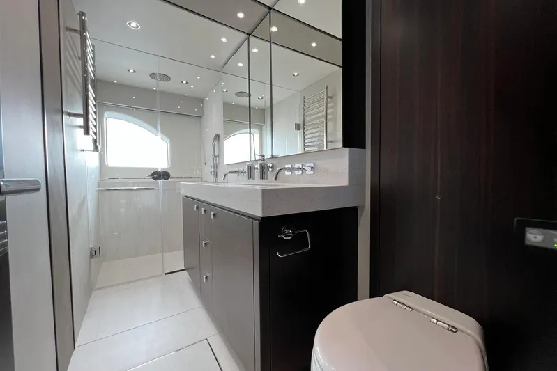  Yacht Photos Pics Luxurious bathroom in 2023 Sunseeker 76 Yacht with modern fixtures and elegant design.