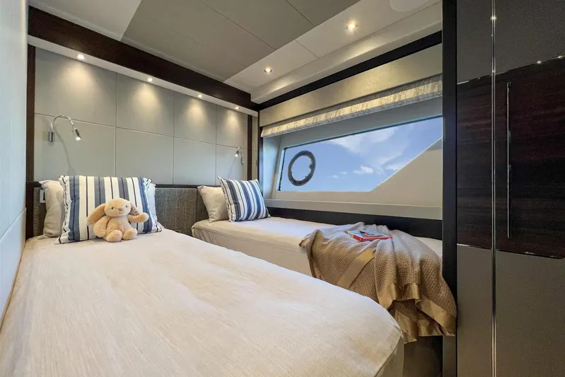  Yacht Photos Pics Luxurious twin bedroom in 2023 Sunseeker 76 Yacht with plush bedding and ocean view.