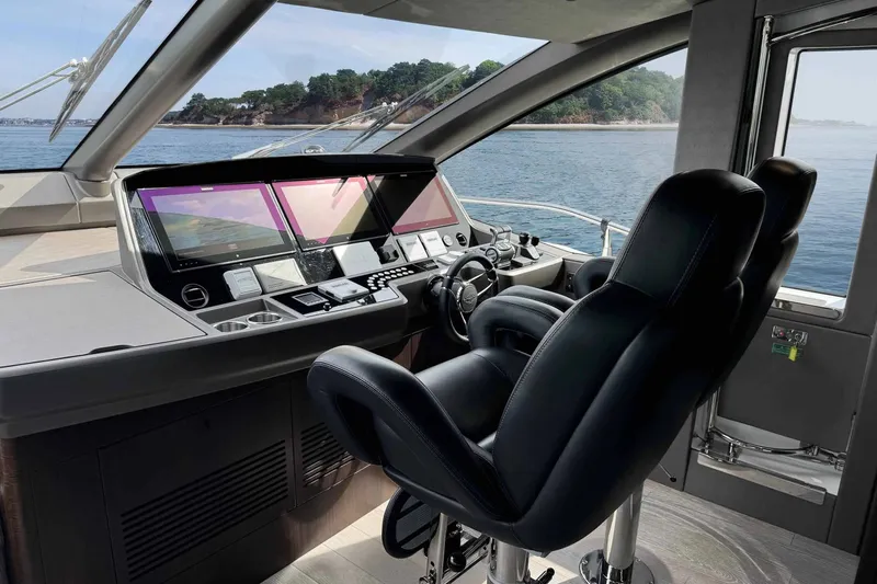  Yacht Photos Pics Luxurious 2023 Sunseeker 76 Yacht helm with modern navigation displays and leather seating.