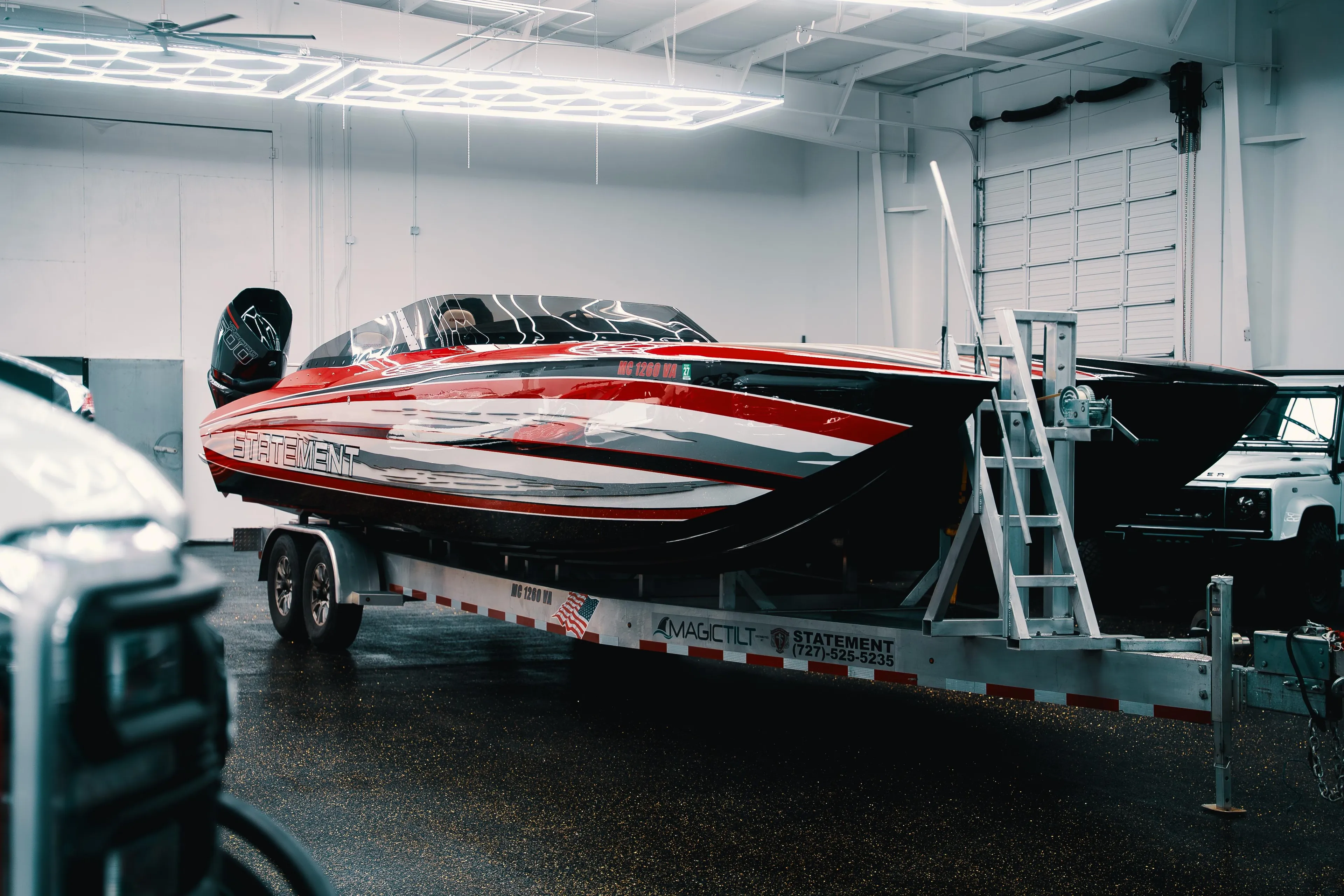 2025 Statement 360 CAT powerboat on trailer in indoor showroom.