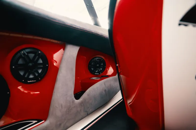  Yacht Photos Pics Interior of 2025 Statement 360 CAT boat with red and gray design, featuring speakers.