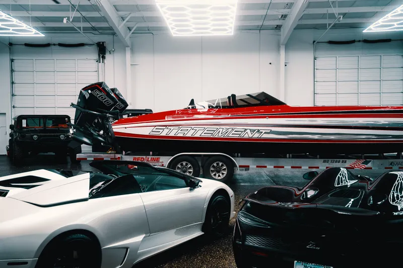  Yacht Photos Pics Luxury cars and a Statement 360 CAT boat in a modern garage, 2025.