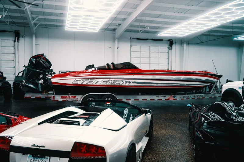  Yacht Photos Pics Red Statement 360 CAT boat on trailer in garage with luxury cars.