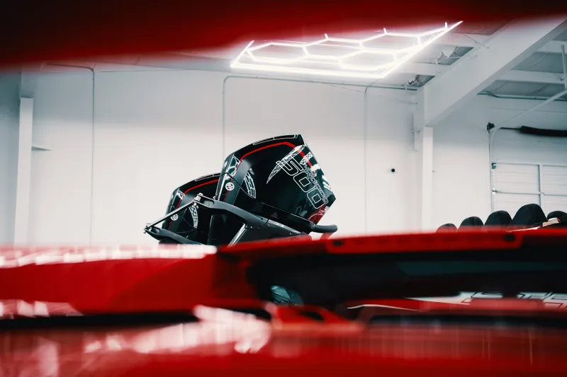  Yacht Photos Pics Red Statement 360 CAT boat in a modern garage, showcasing sleek design and advanced features.