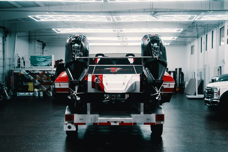  Yacht Photos Pics Red and white Statement 360 CAT boat with dual engines in a modern garage, 2025 model.