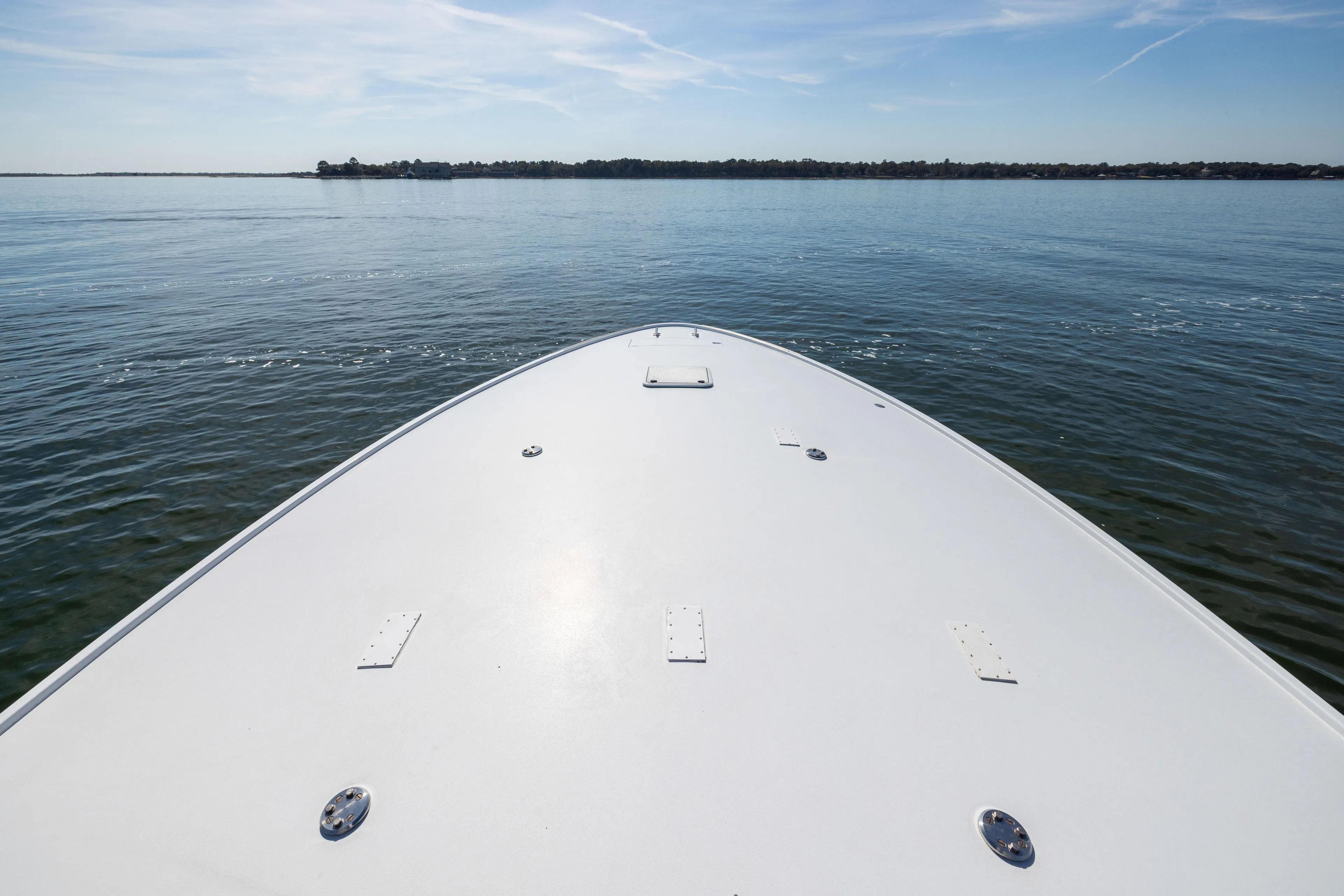 Bow of 1996 Jim Smith 60 Sportfish boat on calm water under clear sky.