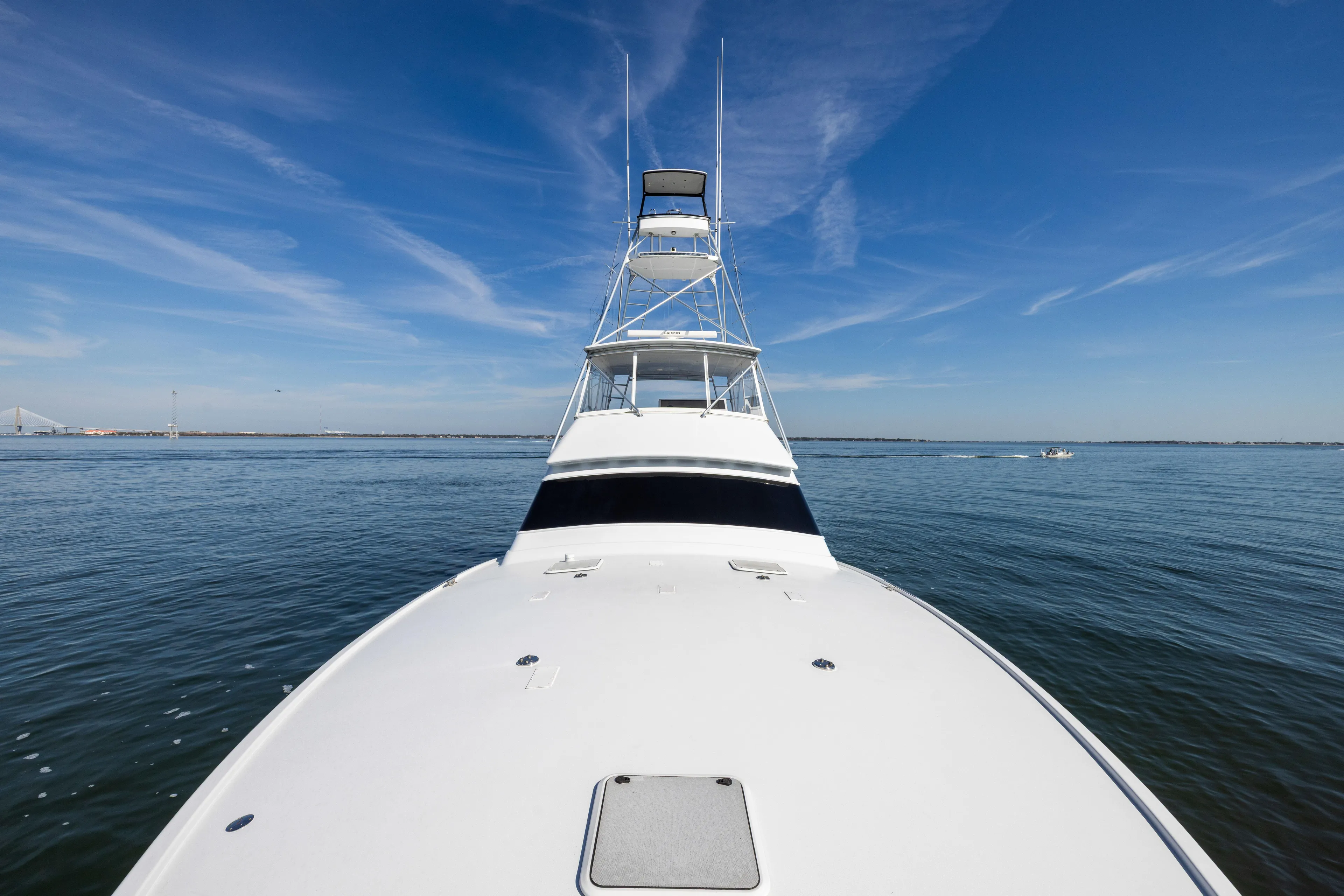 1996 Jim Smith 60 Sportfish yacht on calm ocean under clear blue sky.