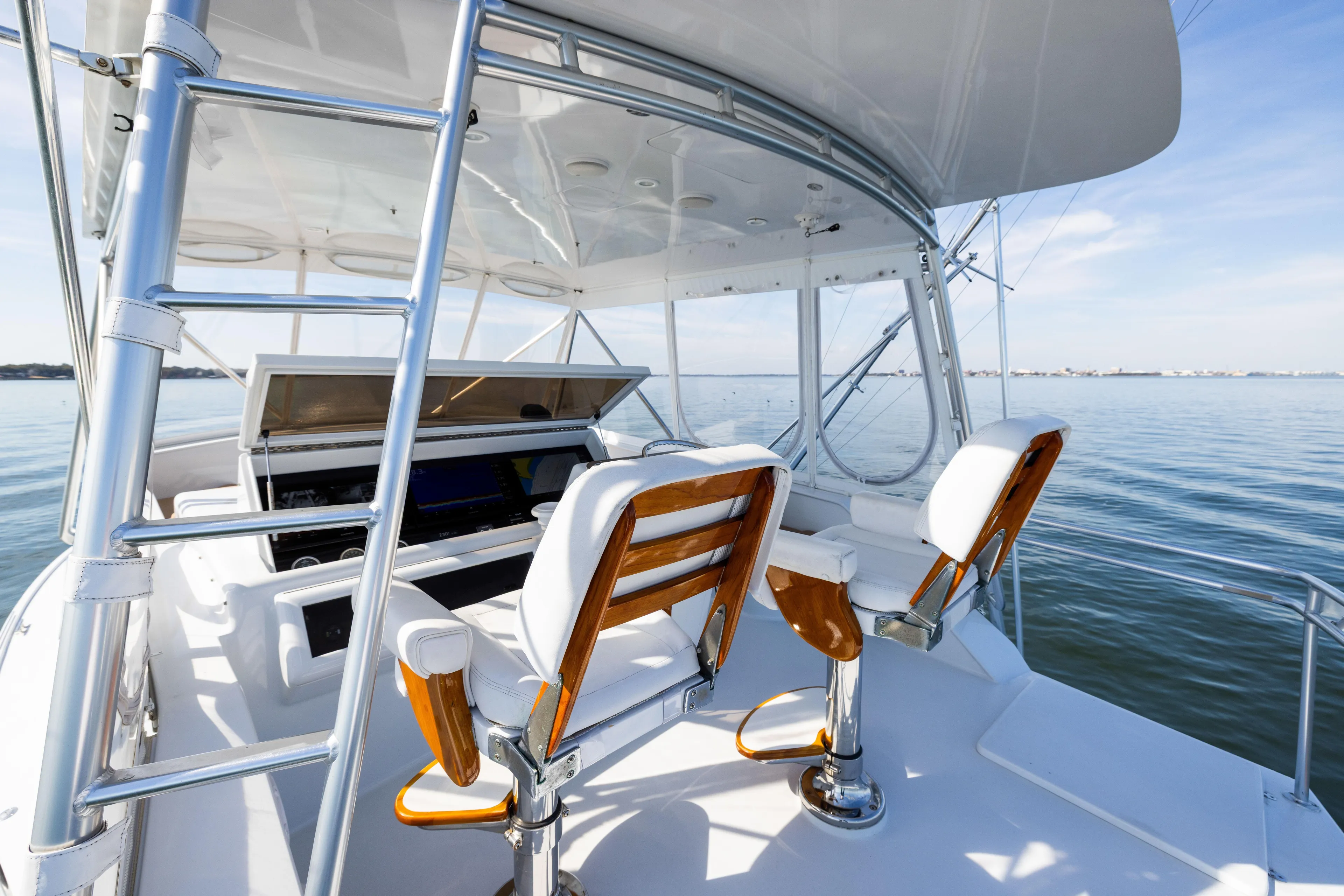 Lay Line Yacht Photos Pics 1996 Jim Smith 60 Sportfish boat helm with ocean view, featuring sleek design and comfortable seating.