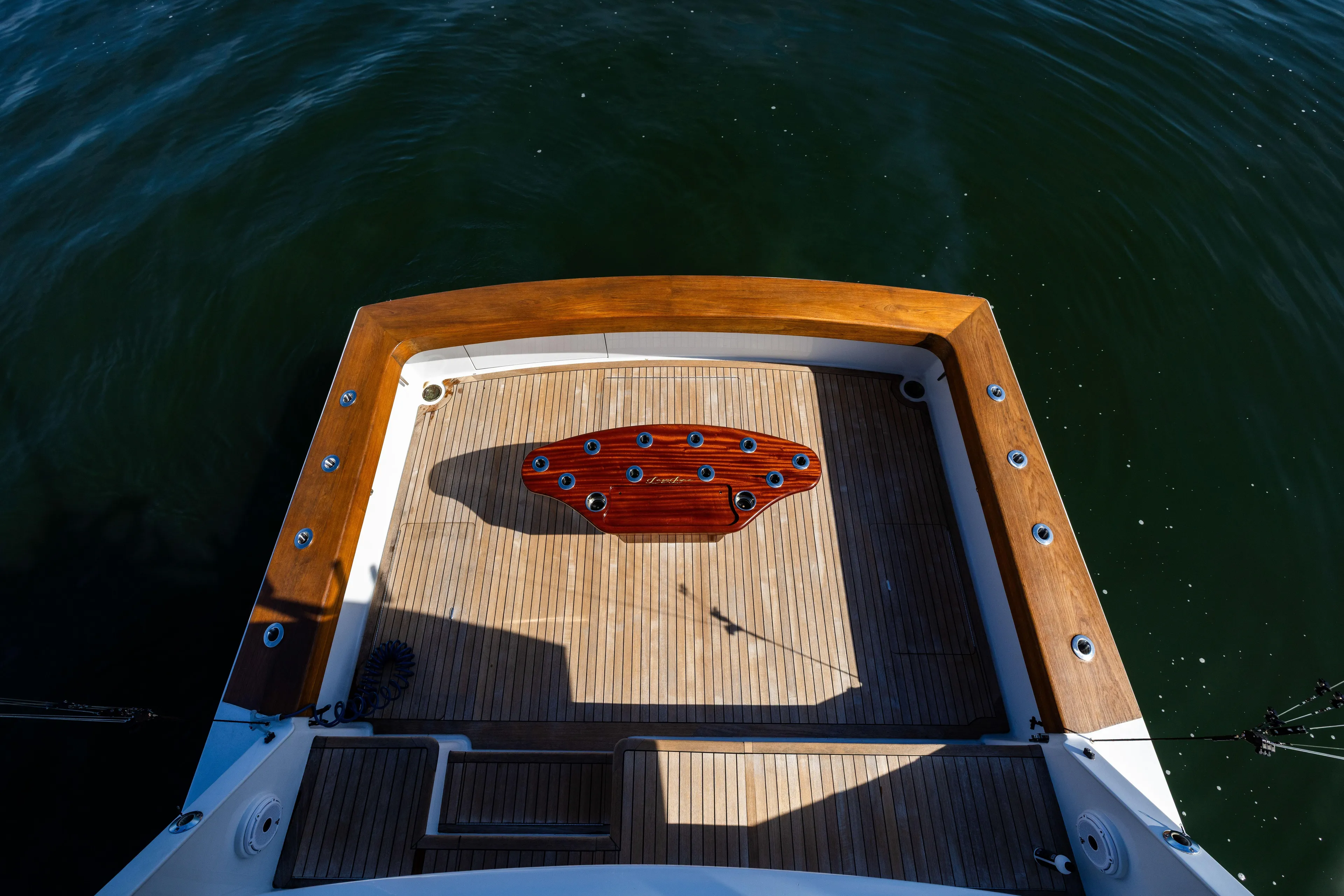 Lay Line Yacht Photos Pics Jim Smith 60 Sportfish 1996 boat deck with wooden finish and fishing rod holders.