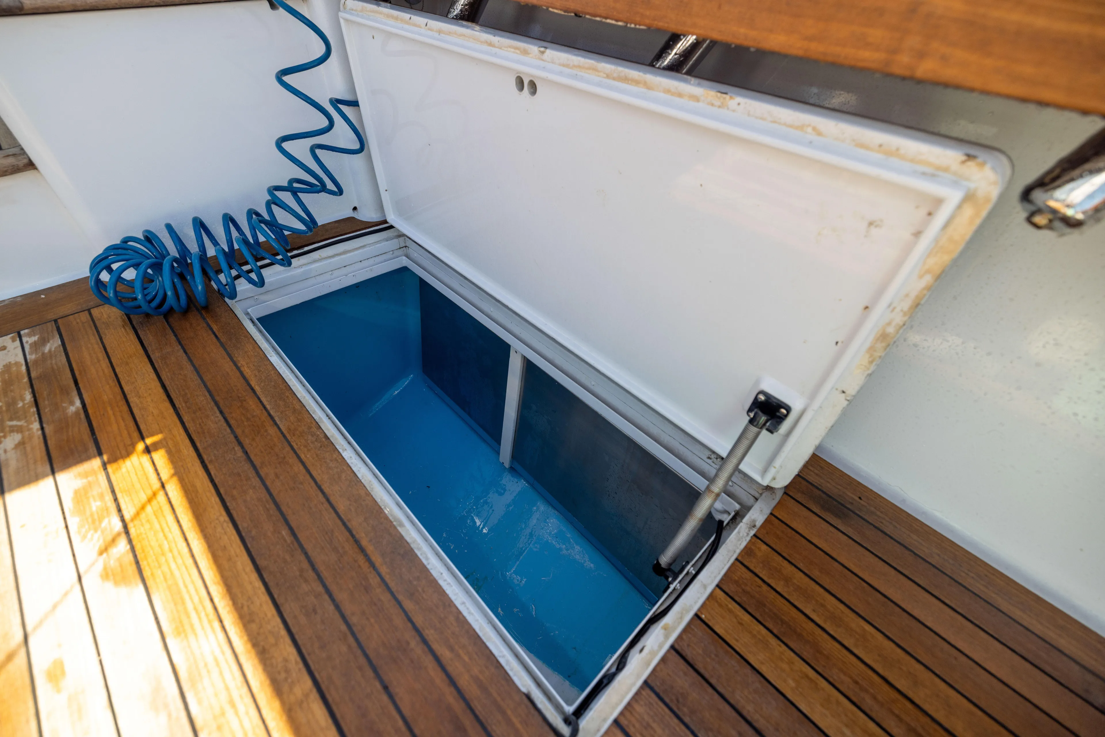 Lay Line Yacht Photos Pics Open storage compartment on 1996 Jim Smith 60 Sportfish boat with wooden deck.