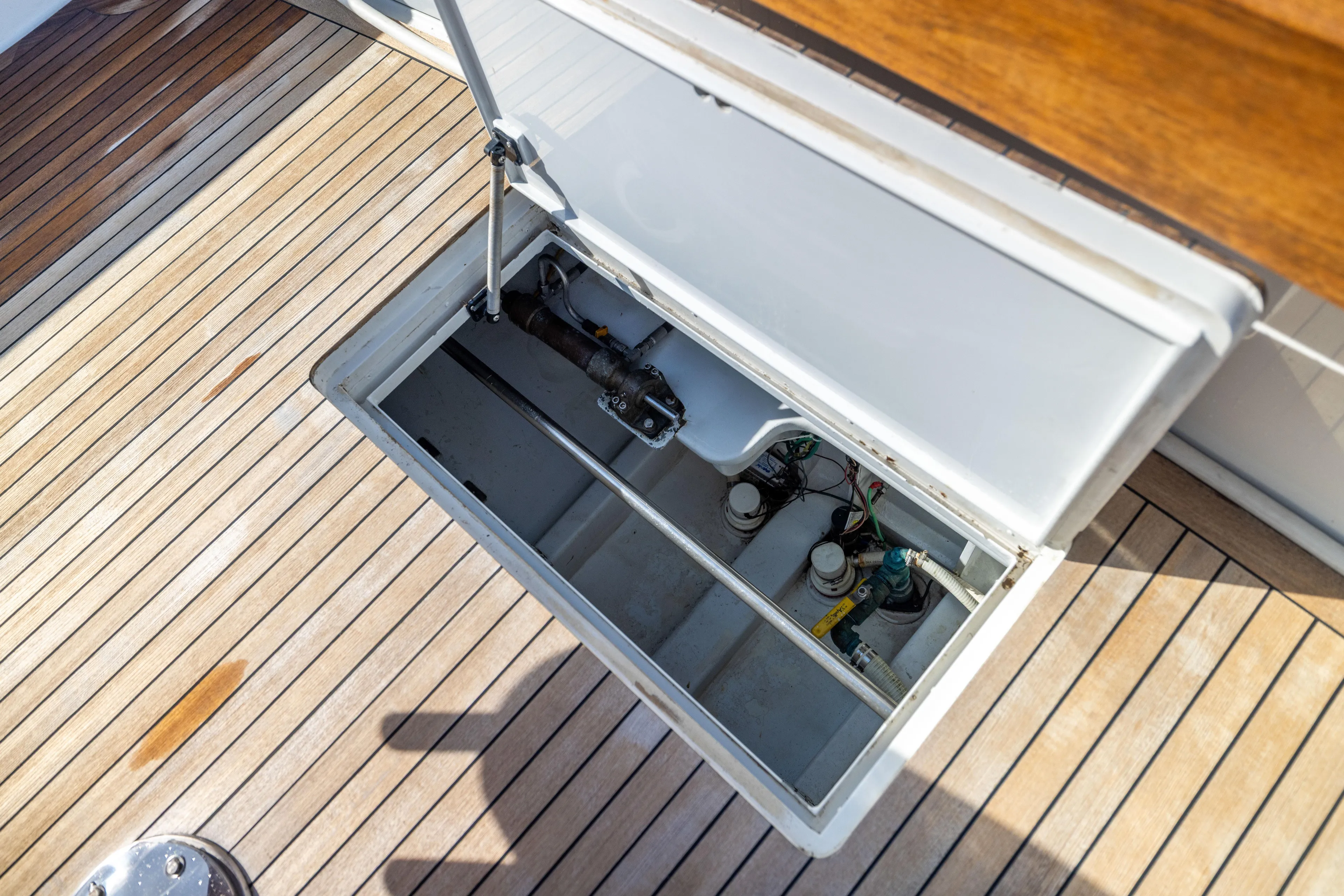 Lay Line Yacht Photos Pics Open hatch on 1996 Jim Smith 60 Sportfish boat deck, revealing mechanical components.