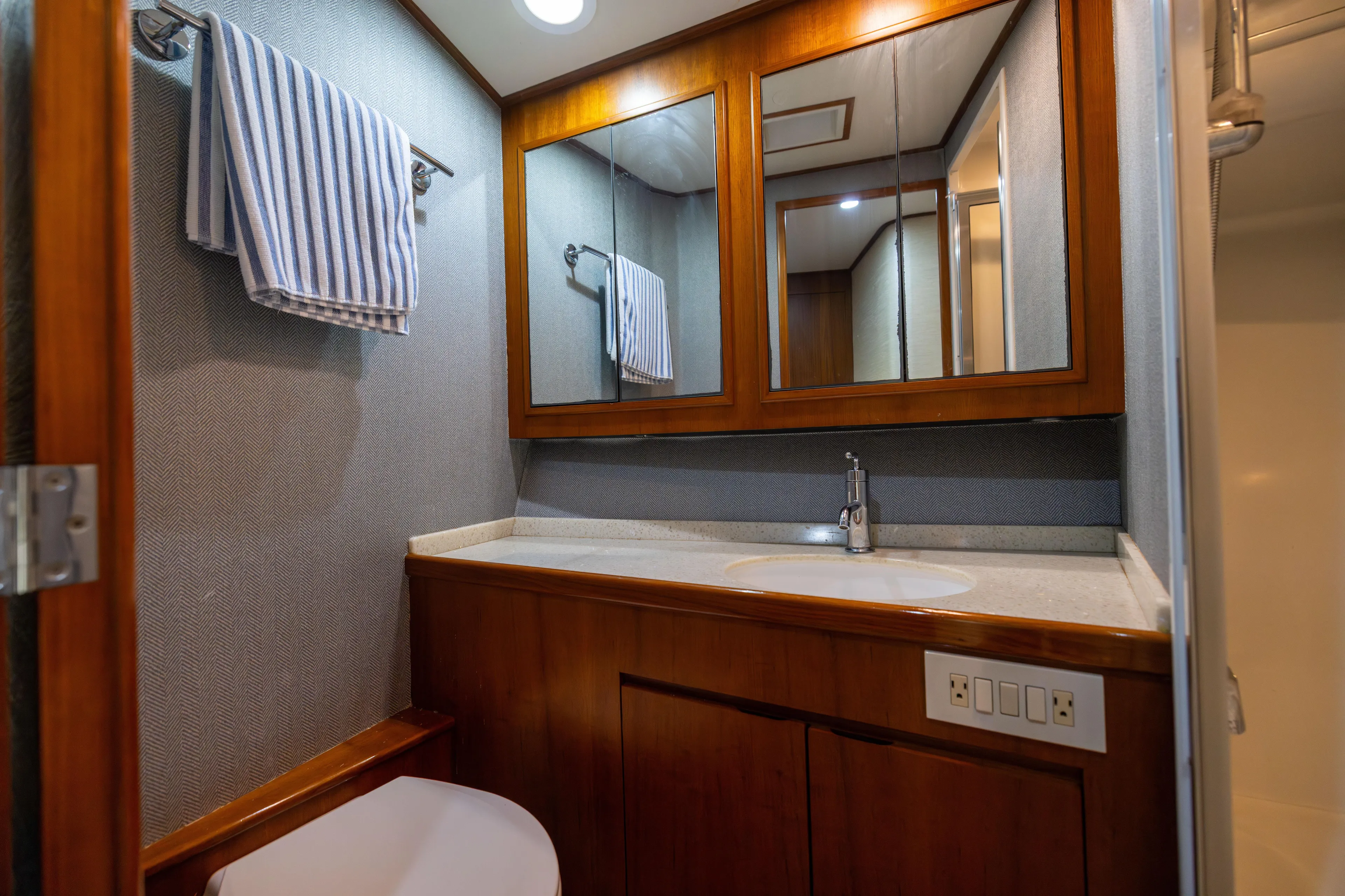 Lay Line Yacht Photos Pics Luxurious bathroom in 1996 Jim Smith 60 Sportfish yacht with wood accents and modern fixtures.