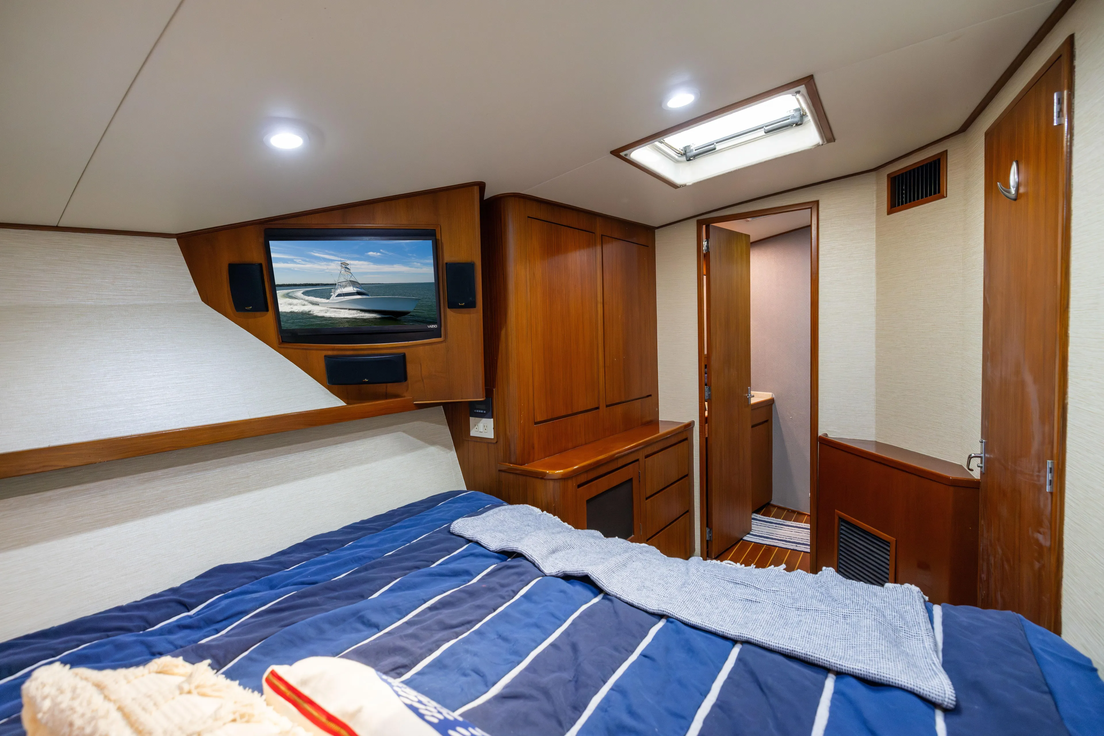 Lay Line Yacht Photos Pics Luxurious cabin interior of a 1996 Jim Smith 60 Sportfish yacht, featuring wood paneling and a TV.