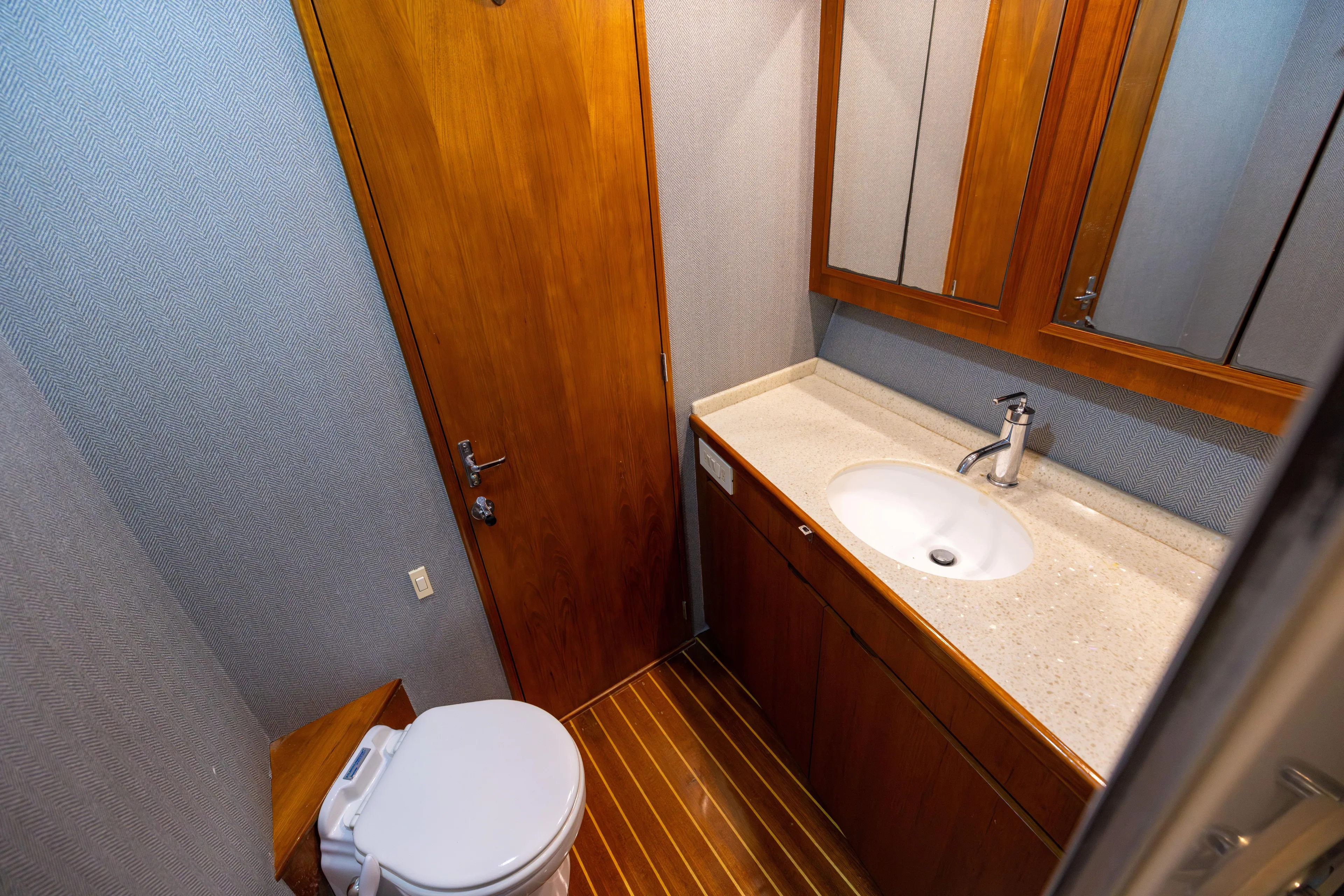 Lay Line Yacht Photos Pics Bathroom interior of 1996 Jim Smith 60 Sportfish yacht with wooden cabinetry and modern fixtures.