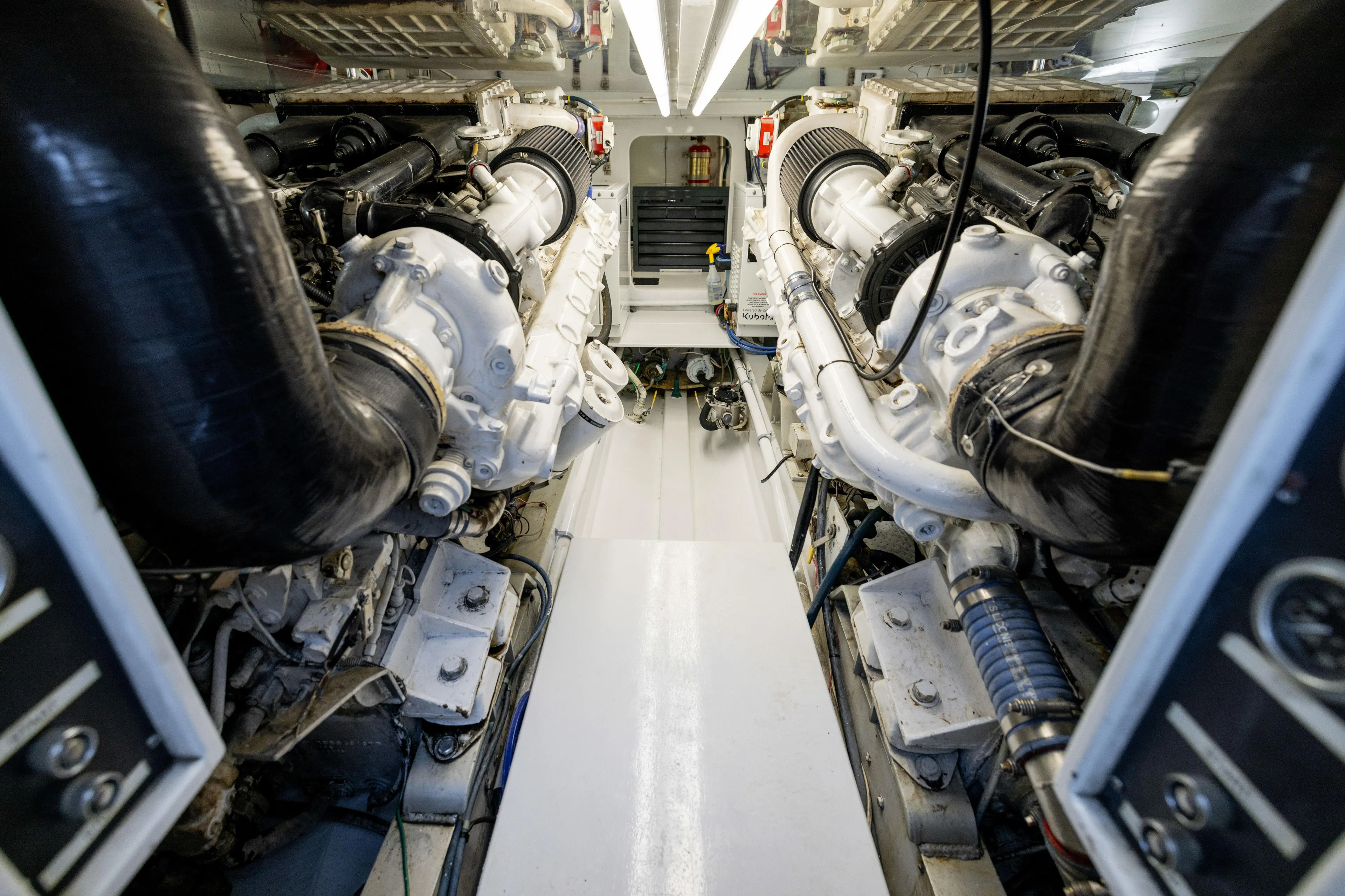 Lay Line Yacht Photos Pics Engine room of a 1996 Jim Smith 60 Sportfish boat, showcasing dual engines.