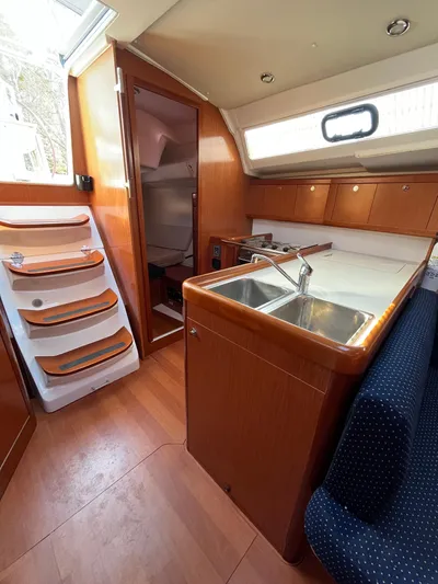 Rosebud Yacht Photos Pics Interior of 2008 Beneteau Oceanis 37 sailboat with kitchen and seating area.
