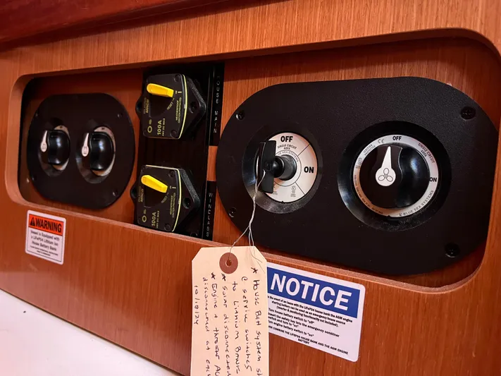 Rosebud Yacht Photos Pics Control panel of a 2008 Beneteau Oceanis 37 sailboat with switches and notices.