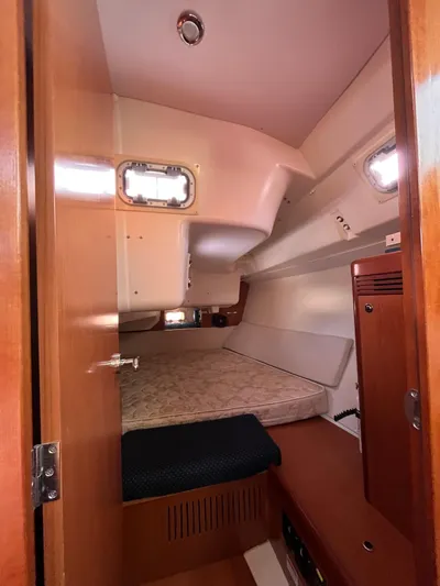 Rosebud Yacht Photos Pics 2008 Beneteau Oceanis 37 cabin interior with bed and wooden furnishings.