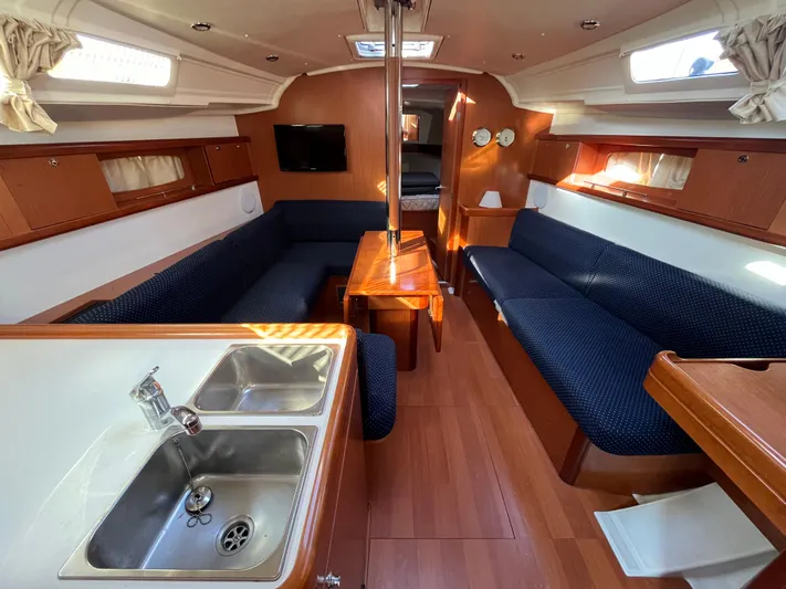 Rosebud Yacht Photos Pics Interior of 2008 Beneteau Oceanis 37 sailboat with cozy seating and kitchen area.