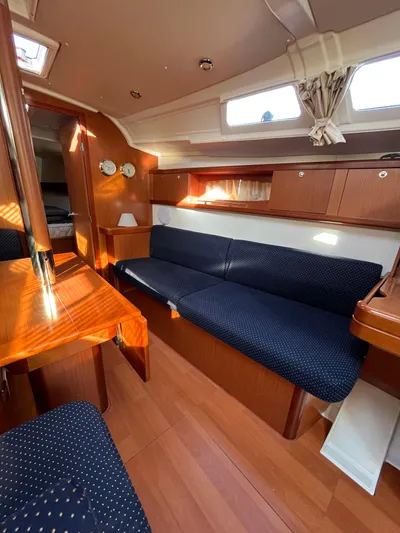 Rosebud Yacht Photos Pics Interior of 2008 Beneteau Oceanis 37 sailboat with wood finish and blue seating.