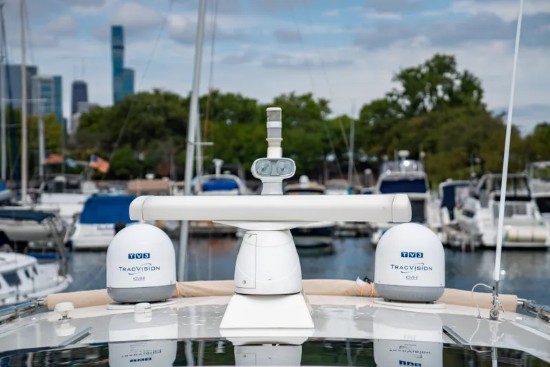  Yacht Photos Pics Sabre 48 Salon Express 2015 yacht with KVH TracVision domes in marina setting.