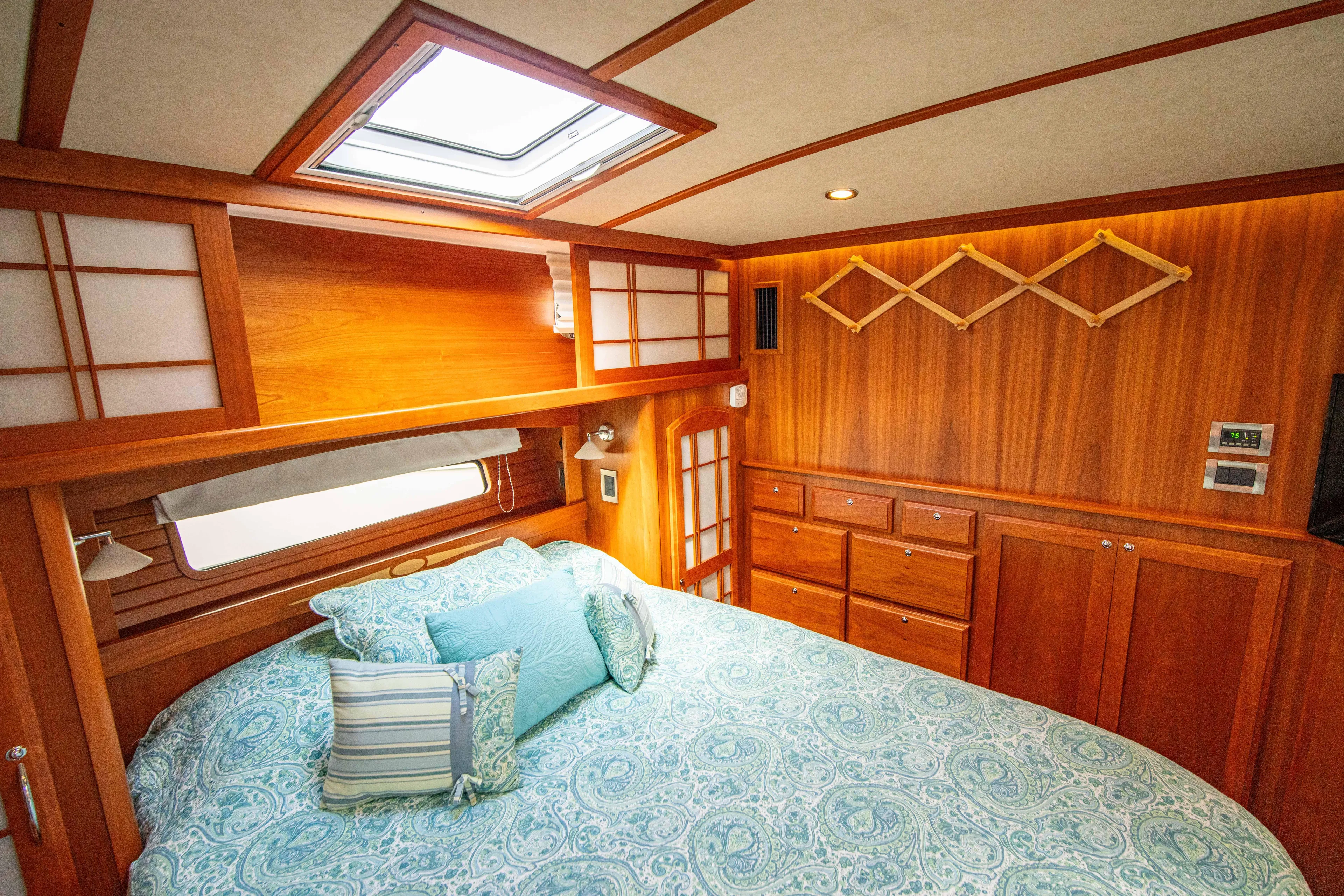  Yacht Photos Pics Luxurious 2015 Sabre 48 Salon Express bedroom with wood paneling and skylight.