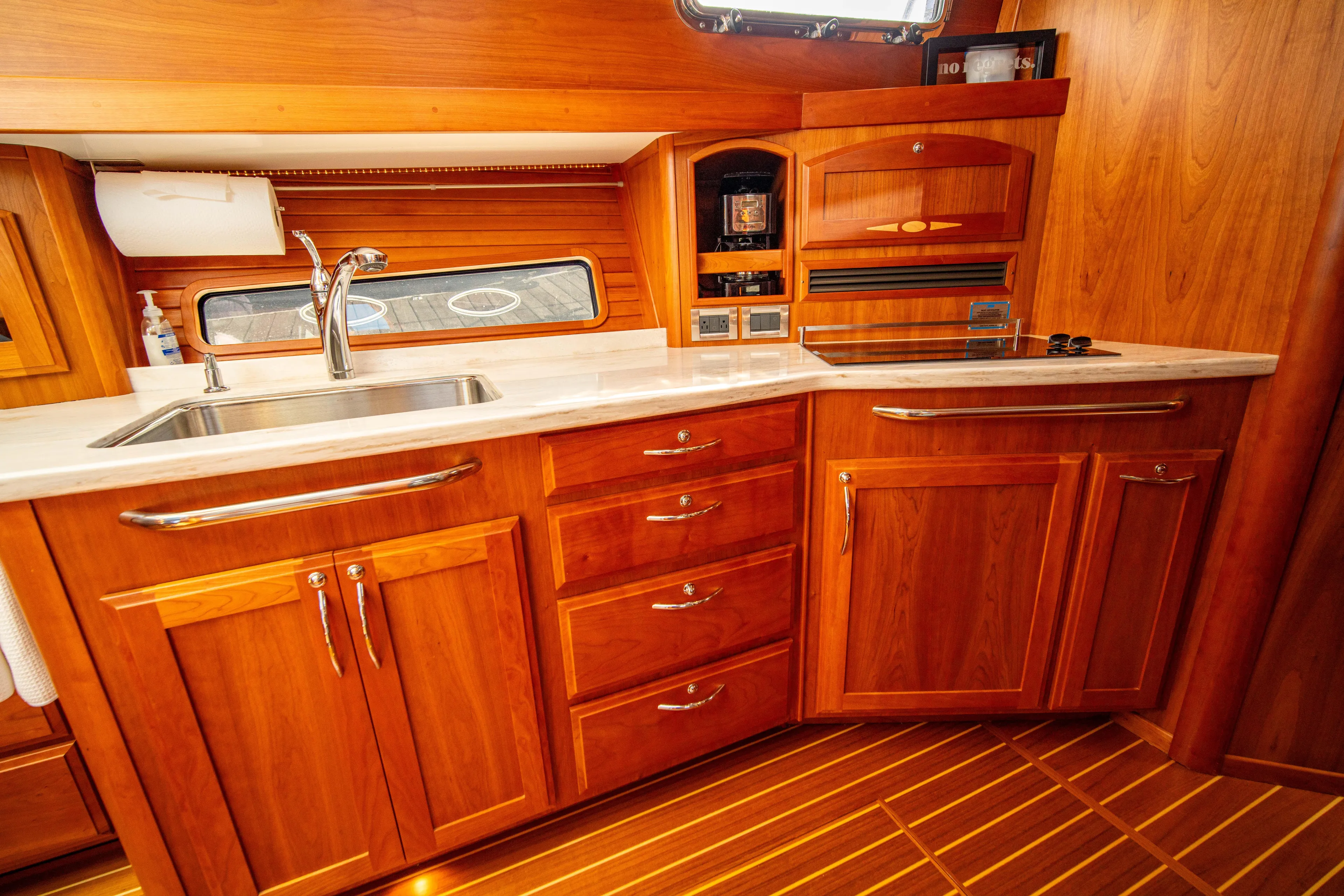  Yacht Photos Pics Luxurious 2015 Sabre 48 Salon Express yacht kitchen with wooden cabinetry and modern appliances.